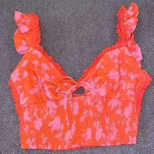 Orangeish/red and pink crop top with ties on front and back.